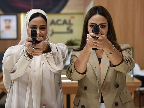 Visitors inspect pistol gun during the 20th edition of the Abu Dhabi International Hunting and Equestrian Exhibition (ADIHEX) in Abu Dhabi National Exhibition Centre (ADNEC). File photo