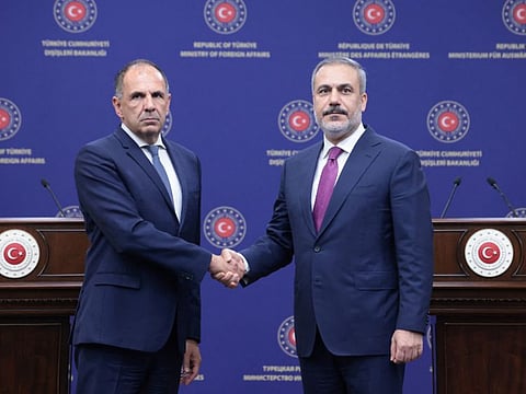 Turkish Foreign Minister Hakan Fidan shakes hands with his Greek counterpart George Gerapetritis during a press conference in Ankara on September 5, 2023.