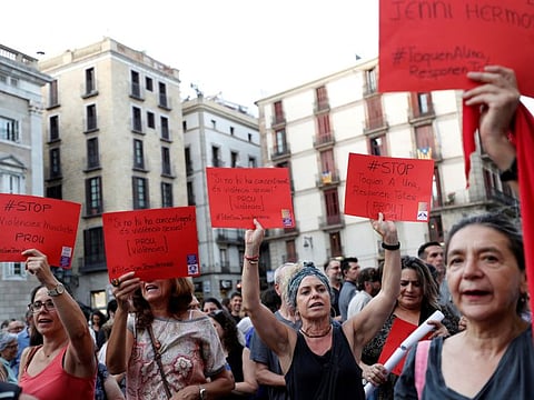 Women hold placards, depicting red card in football, that read "Stop Violence against Women" during a protest against Royal Spanish Football Federation President Luis Rubiales and in support of the player Jenni Hermoso at Sant Jaume Square in Barcelona on September 4.