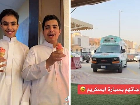 Students enjoy ice cream brought by their teacher, and the truck is on the right.
