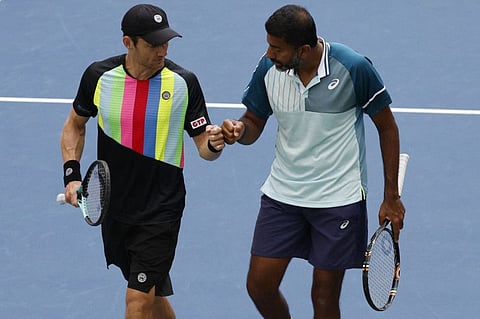 Matthew Ebden (left) and Rohan Bopanna of India celebrate between points against Nicolas Mahut and Pierre-Hugues Herbert of France in the men's doubles semifinals.