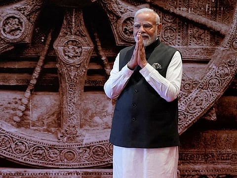 Indian Prime Minister Narendra Modi greets as waits to welcome leaders of the G20 countries, in New Delhi, India, Saturday, Sept. 9, 2023