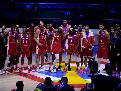 Canada players pose for a photo after the Basketball World Cup bronze medal game against United States in Manila, Philippines, on Sunday.