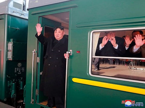 North Korean leader Kim Jong Un waves from a train before leaving Pyongyang Station, North Korea, for Vietnam, on February 23, 2019.