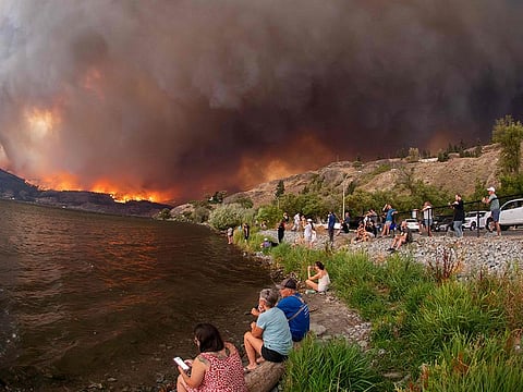 Residents watch the McDougall Creek wildfire in West Kelowna, British Columbia, Canada, on August 17, 2023