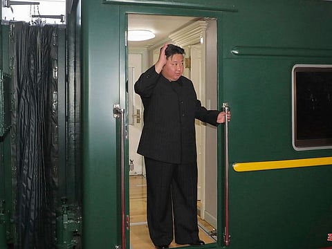 North Korea leader Kim Jong Un waves from a train in Pyongyang, North Korea, as he leaves for Russia.