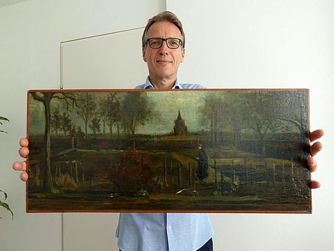 Dutch art detective Arthur Brand with the painting title "Parsonage Garden at Nuenen in Spring", painted by Vincent van Gogh in 1884, at his home in Amsterdam.