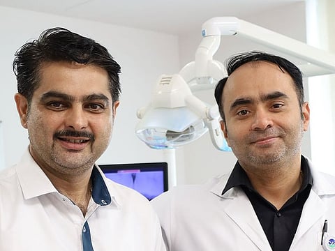 Muhammed Khalid, left, with Dr Renju Prem who treated him.