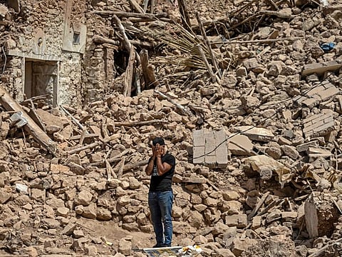 A volunteer reacts amid the rubble of destroyed houses in the village of Douzrou on September 12, 2023 following a 6.8-magnitude quake.