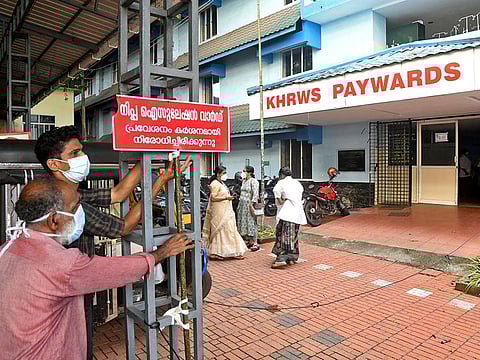 Staff members install a sign reading "Nipah isolation ward, entry strictly prohibited" at a hospital where a ward is being prepared for suspected Nipah virus patients in Kozhikode district, Kerala, India, September 12, 2023.