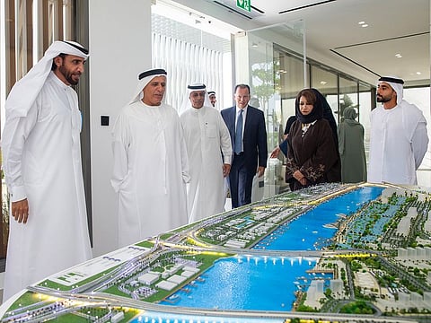 Mattar Al Tayer (second from left), Director-General, Chairman of the Board of Executive Directors, RTA, and Mohammed Ibrahim Al Shaibani (left), Chairman of the Board of Directors, Nakheel, next to a model of the project