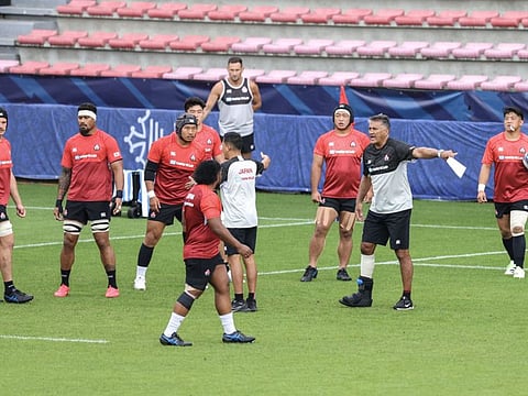 Japan's New Zealand-born Japanese head coach Jamie Joseph talks to his players during a training session at the Ernest-Wallon stadium in Toulouse, southwestern France, on Wednesday.