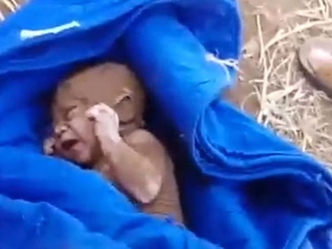 The infant was found alive after rescuers heard crying and dug through the ruins