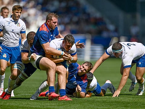 Italy's fly-half Paolo Garbisi (centre) is tackled by Namibia's flanker Wian Conradie during the World Cup Pool A match at Stade Geoffroy-Guichard in Saint-Etienne, south-eastern France on September 9.