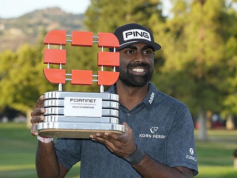 Sahith Theegala poses with his trophy on the 18th green of the Silverado Resort North Course