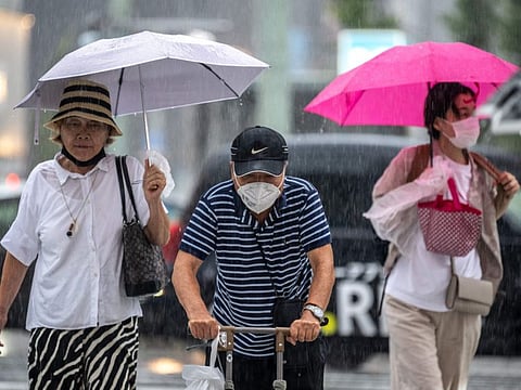 Pedestrians  walk in heavy rain in the Ginza shopping area of Tokyo on September 15, 2023.  “Japan has the highest percentage of elderly population in the world.