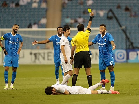 Al Hilal's Neymar is shown a yellow card by referee Mohammed Abdulla Hassan Mohamed during the Asian Champions League Group D against Navbahor Namangan in King Fahd International Stadium, Riyadh, Saudi Arabia on Monday.