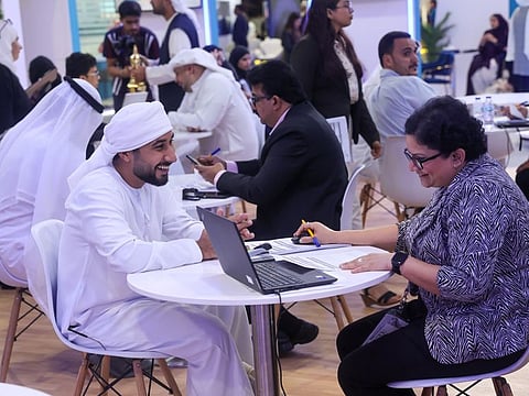 Emirati candidates at Al Rostamani Group stand on the opening day of Ru'ya Careers UAE Redefined 2023 job fair at Dubai World Trade Centre