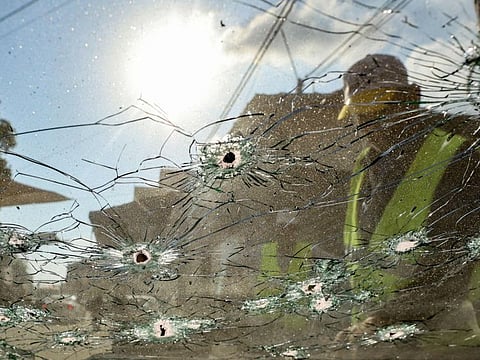 A man inspects the bullet hole-ridden windshield of a vehicle after a raid by Israeli forces in the Jenin camp for Palestinian refugees on September 20, 2023.