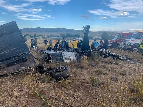 Members of the Truckee Meadows Fire and Rescue Department and other officials look over aircraft wreckage, Sunday, Sept. 17, 2023, in Reno, Nev., after two California pilots were killed when their planes collided in mid-air while preparing to land after completing a race at the National Championship Air Races north of Reno.