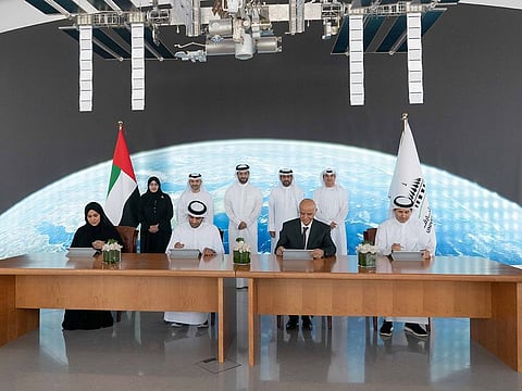 (centre, back row) Sheikh Sultan bin Ahmed bin Sultan Al Qasimi, Deputy Ruler of Sharjah and President of the University of Sharjah, witnessing the signing of the agreement between representatives from various entities collaborating in the satellite project