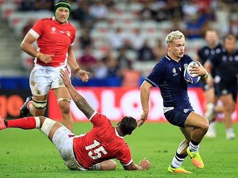 Scotland's wing Darcy Graham (right) runs to score a try during the Rugby World Cup Pool B match against Tonga at Stade de Nice , southern France on Sunday.