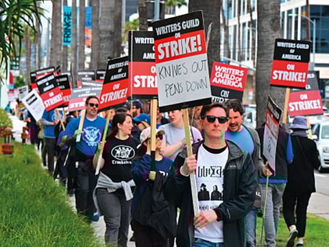 Writer Eric Heisserer joins others on the picket line in front of Netflix in Hollywood in May.