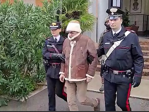 Italy's top wanted mafia boss, Matteo Messina Denaro (centre) being transferred from the Carabinieri police station of San Lorenzo in Palermo, to an undisclosed location, following his arrest in his native Sicily on January 16, 2023.