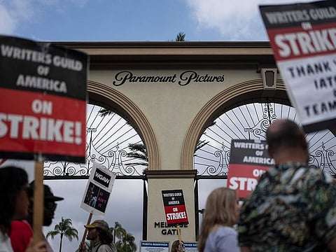 Demonstrators walk with signs during a rally in Los Angeles.
