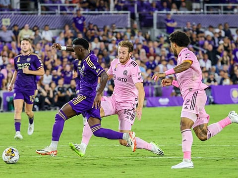 Iván Angulo of Orlando City SC drives past Ryan Sailor and DeAndre Yedlin of Inter Miami CF during the second half at Exploria Stadium.