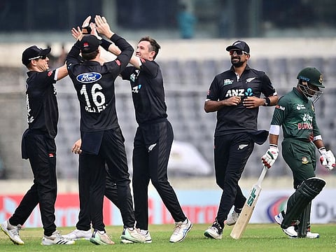 New Zealand's Adam Milne (3R) celebrates with teammates after taking the wicket of Bangladesh's Zakir Hasan during the third and final ODI at the Sher-e-Bangla National Cricket Stadium in Dhaka on September 26, 2023.