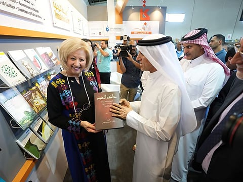 The Jordanian Minister of Culture Haifa Yousef Fadel Najjar upon receiving a copy of the book “The Inquisition Manuscripts” during her visit to the SBA pavilion.