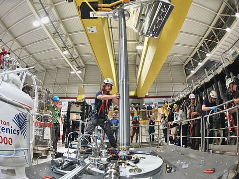This handout photograph released by CERN on September 27, 2023, shows the insertion of ALPHA-g apparatus at CERN in Geneva on October 15, 2018. For the first time, scientists have observed antimatter particles - the mysteriously absent twins of the visible matter all around us - falling downwards due to the effect of gravity, Europe's physics lab CERN announced on September 27, 2023.