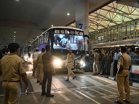 Police personnel stand guard around a bus carrying Pakistans cricket team at the Rajiv Gandhi International Airport in Hyderabad on Wednesday.