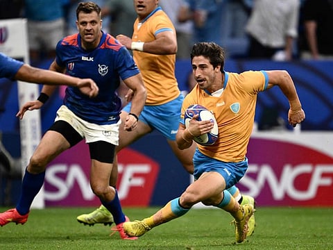 Uruguay's scrum-half Santiago Arata runs to score a try during the Rugby World Cup Pool A match against Namibia at OL Stadium in Lyon, south-eastern France, on Wednesday.