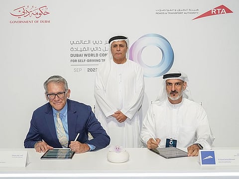 Mattar Al Tayer (standing) watches while Ahmed Bahrozyan, CEO of the Public Transport Agency and Frank Menchaca, President of SAE’ Sustainable Mobility Solutions signs an MoU on Wednesday in Dubai