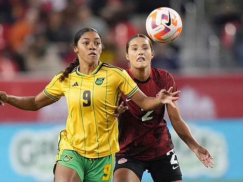 Canada's Sydney Collins (right) battles with Jamaica's Kameron Simmonds for the ball during their CONCACAF women's championship in Toronto on Tuesday.