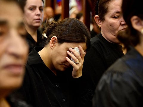 Mourners attend a mass for the victims of the wedding hall fire at a church in Qaraqosh.