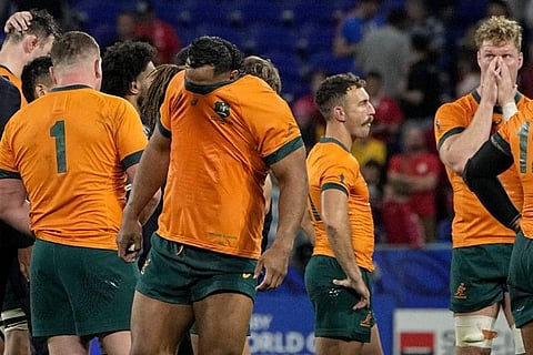 Australia's Pone Fa'Amausili covers his face after his side's 6-40 lost against Wales during a Rugby World Cup Pool C match in Lyon.