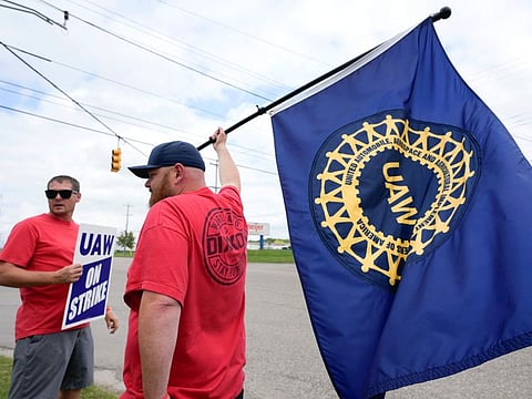 The United Auto Workers union expanded its two-week strikes against Detroit automakers Friday, adding 7,000 workers at a Ford plant in Chicago and a General Motors assembly factory near Lansing, Michigan.