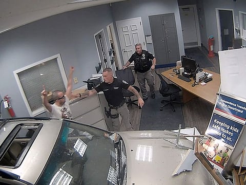 In this image taken from video released by the Warren County Prosecutor’s Office, police detain John Hargreaves, 34, after he drove his SUV through the police headquarters in Independence Township, N.J. on Sept. 20, 2023.