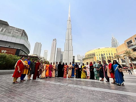 The visiting moms outside Dubai Mall, with the world's tallest tower, the Burj Khalifa, behind them