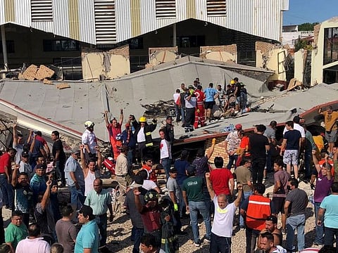This handout picture released by the Tamaulipas Civil Protection shows rescuers and members of Civil Protection working to rescue people who were trapped after a church roof collapsed in Ciudad Madero, Tamaulipas State, Mexico, on October 1, 2023.