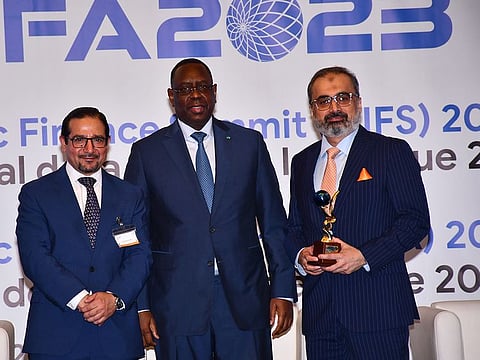 From left to right: Dr Humayon Dar, Director General of the Cambridge Institute of Islamic Finance, Macky Sall, President of Senegal, and Adnan Fasih, Group Head of Islamic Banking at Habib Bank AG Zurich with the Championship Award for Global Islamic Banking Franchise at GIFA 2023