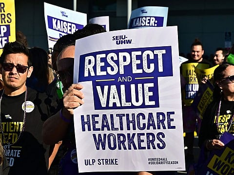 Kaiser Permanente employees, joined by Union members representing the workers, walk the picket line in Los Angeles, California.