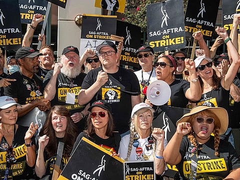 Duncan Crabtree-Ireland (C), executive director and chief negotiator for SAG AFTRA, and the members of the negotiating committee address the SAG AFTRA members at the picket line outside of Warner Brothers in Burbank, California. | File photo