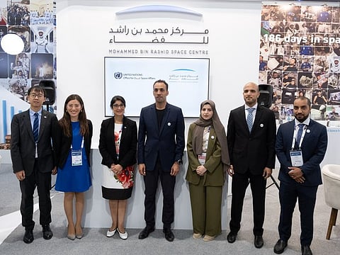 MBRSC Director General Salem Humaid Al Marri (4th from left) and UNOOSA Director Aarti Holla-Maini (3rd from left) standing for a photograph after signing an MoU in Dubai.