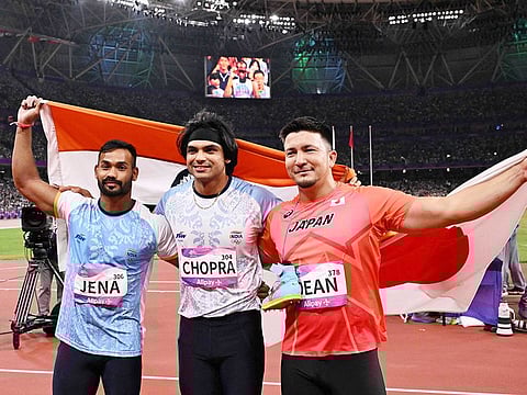 From left: Silver medallist India’s Kishore Jena, gold medallist India’s Neeraj Chopra, and bronze medallist Japan’s Genki Dean celebrate after the men's javelin throw final athletics event during the 2022 Asian Games in Hangzhou in China's eastern Zhejiang province on October 4, 2023.