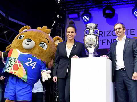 Former German players Philipp Lahm and Celia Sasic with the European Championship trophy and Albart the bear, the official mascot for Euro 2024, during the kick-off event in Hamburg.