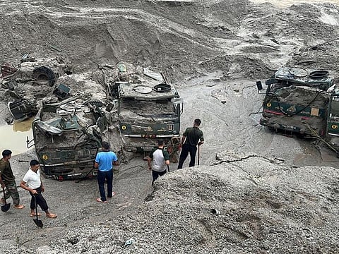 Members of Indian Army try to recover trucks buried at the area affected by flood in Sikkim on October 5, 2023.